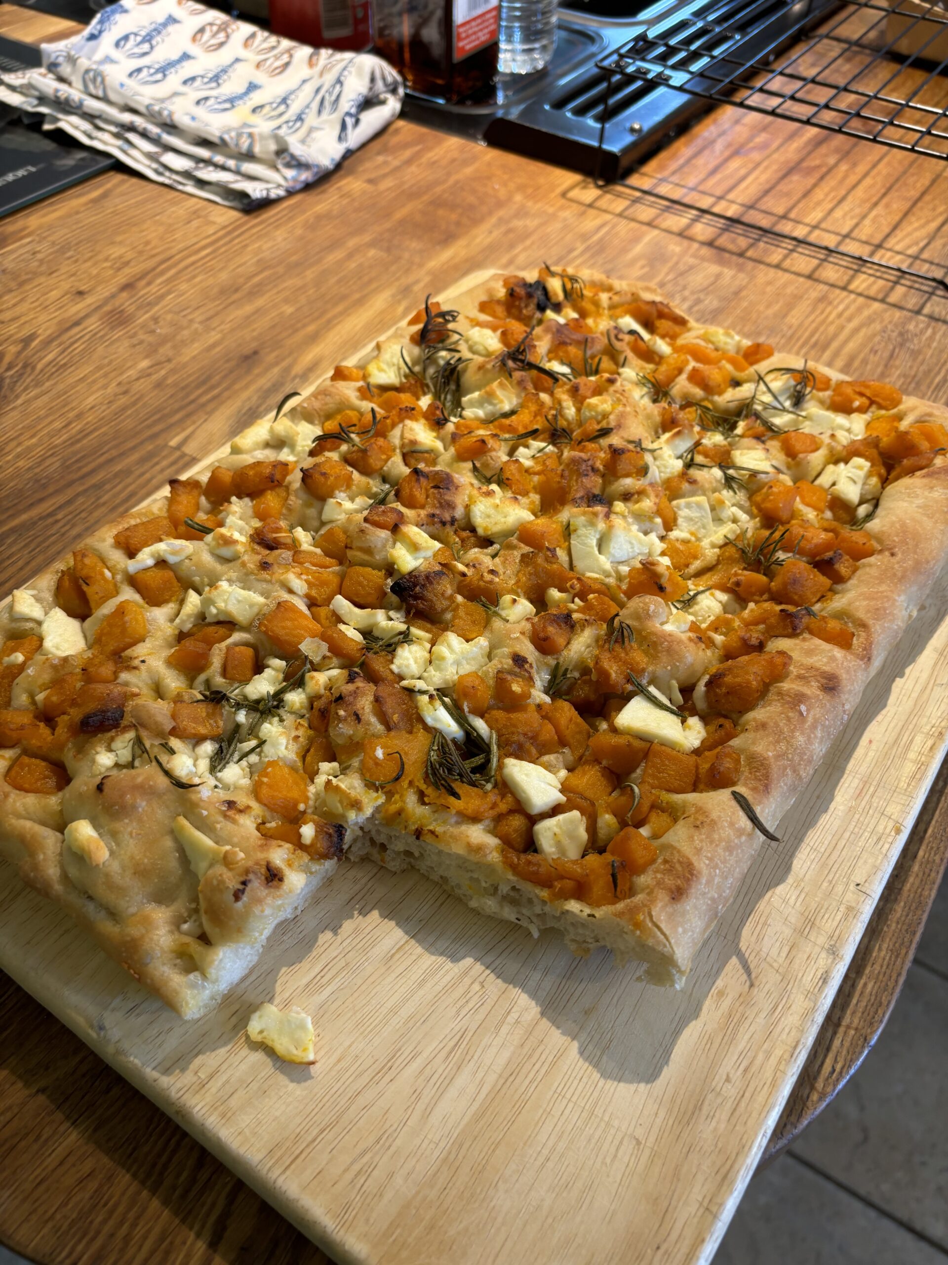 rectangular focaccia with squash, cheese, onions and rosemary